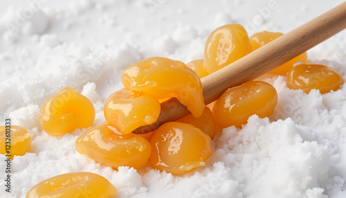 Maple taffy creation process with syrup on snow, seasonal treat