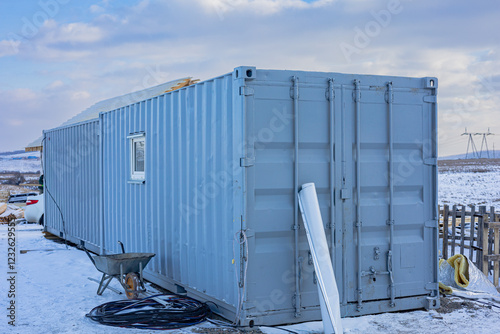 Tableau sur toile Shipping container on a snowy ground modified for use as a small building , as a storage unit, a workshop, or as a small home