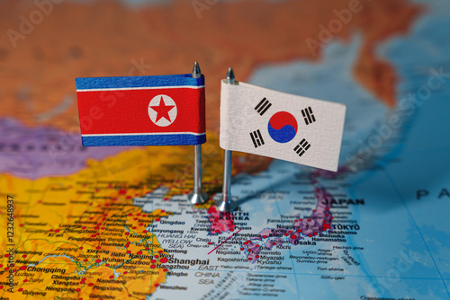 Flags of South Korea and North Korea on geopolitical map