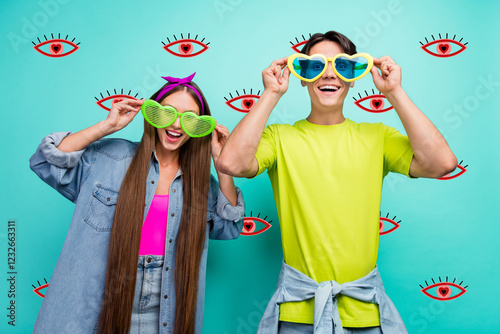 Photo of impressed brunette millennial couple dress eyewear colorful t-shirts isolated on teal color background