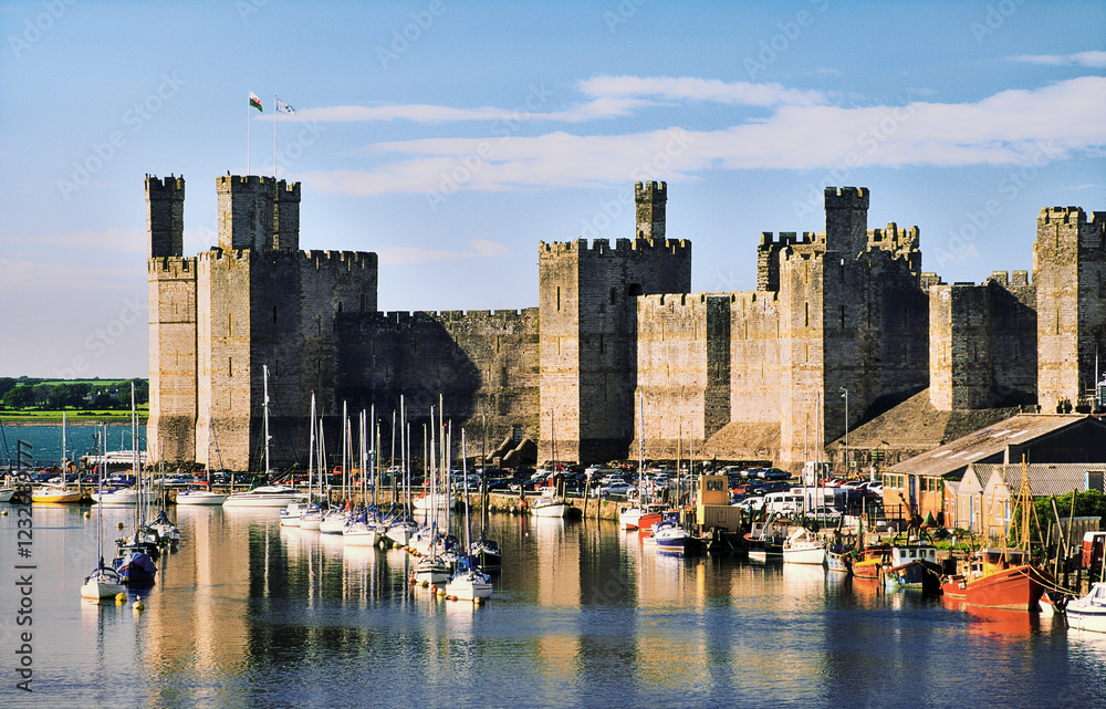 Caernarfon Castle in the Gwynedd, Snowdonia region of north Wales, UK. Seen across the mouth of the River Arfon