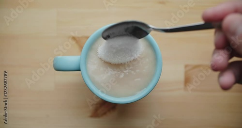 Tranquil and serene top view of light blue coffee mug filled to the brim with a creamy and inviting beverage