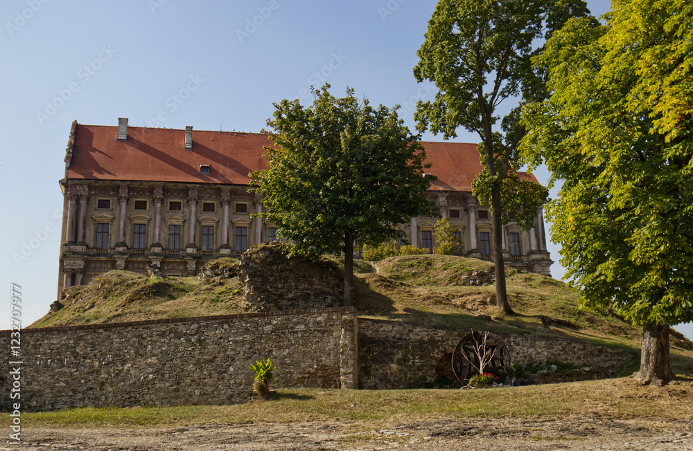 A unique castle building. A unique historical building. A park with a hill and trees in front of the castle building. Traveling around the Czech Republic. Monuments of the Czech Republic. Holiday. A unique castle building. A unique historical building. A park with a hill and trees in front of the castle building. Traveling around the Czech Republic. Monuments of the Czech Republic. Holiday.