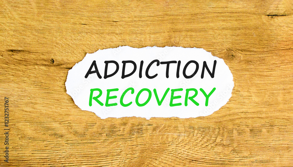 Addiction recovery symbol. Concept words Addiction recovery on beautiful white paper. Beautiful wooden table wooden background. Psychology addiction recovery concept. Copy space. Addiction recovery symbol. Concept words Addiction recovery on beautiful white paper. Beautiful wooden table wooden background. Psychology addiction recovery concept. Copy space.
