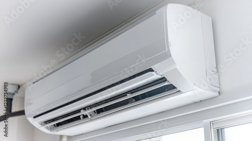 air conditioner indoor unit installed on a wall above the window