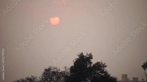 Fast sunset in cloudy weather in urban area