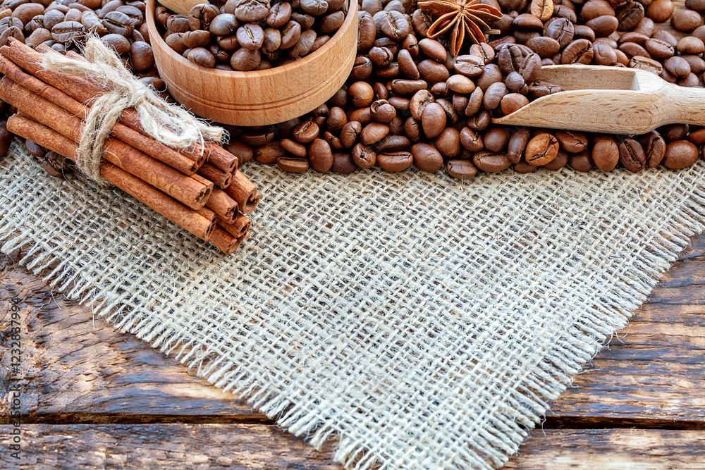 Rich aromatic coffee beans and spices arranged on rustic wooden table with natural textures