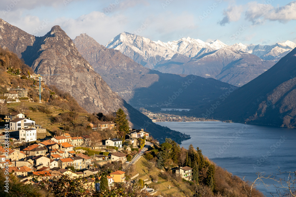 Obraz premium Sunset view of the village on Monte Bre, with Lake Lugano and the Alps, Switzerland