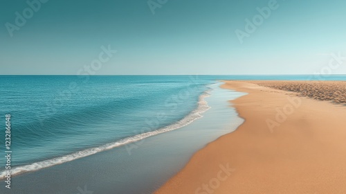 Calm beach with gentle waves and clear blue sky near the shore during daylight