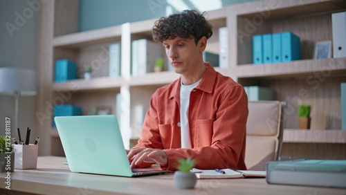 Focused entrepreneur working online developing startup on laptop. Serious man