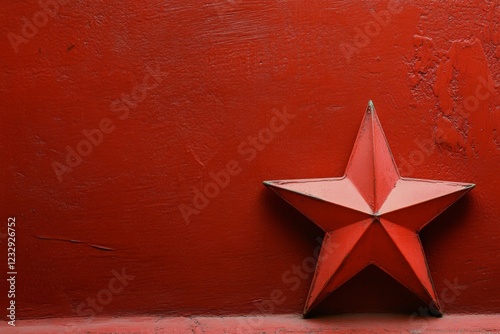 Red star sculpture against a vibrant red background with geometric design ele...