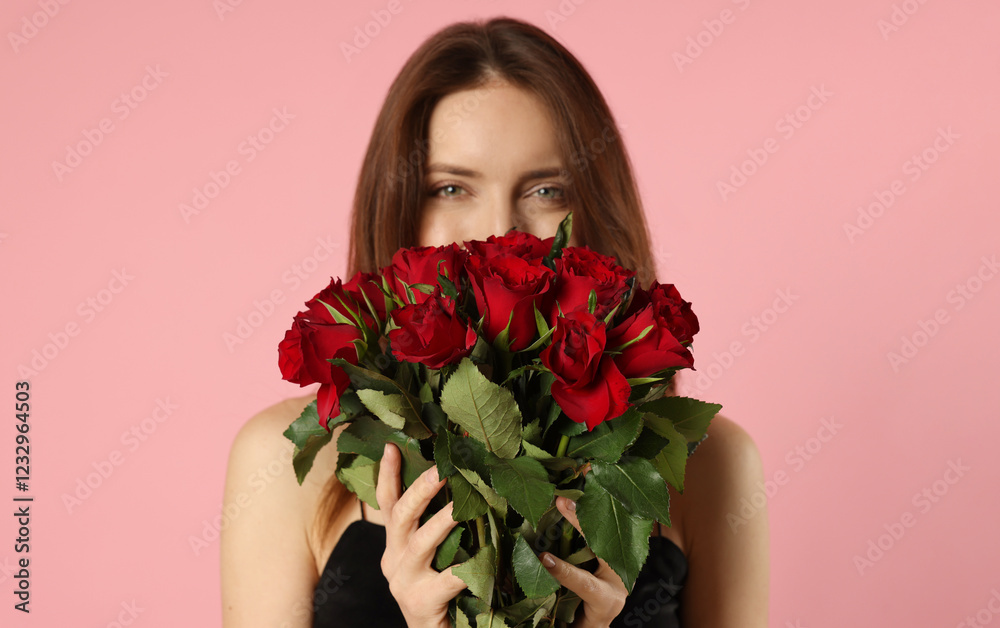 Happy Valentine's Day. Beautiful woman with bouquet of roses on pink background Happy Valentine's Day. Beautiful woman with bouquet of roses on pink background