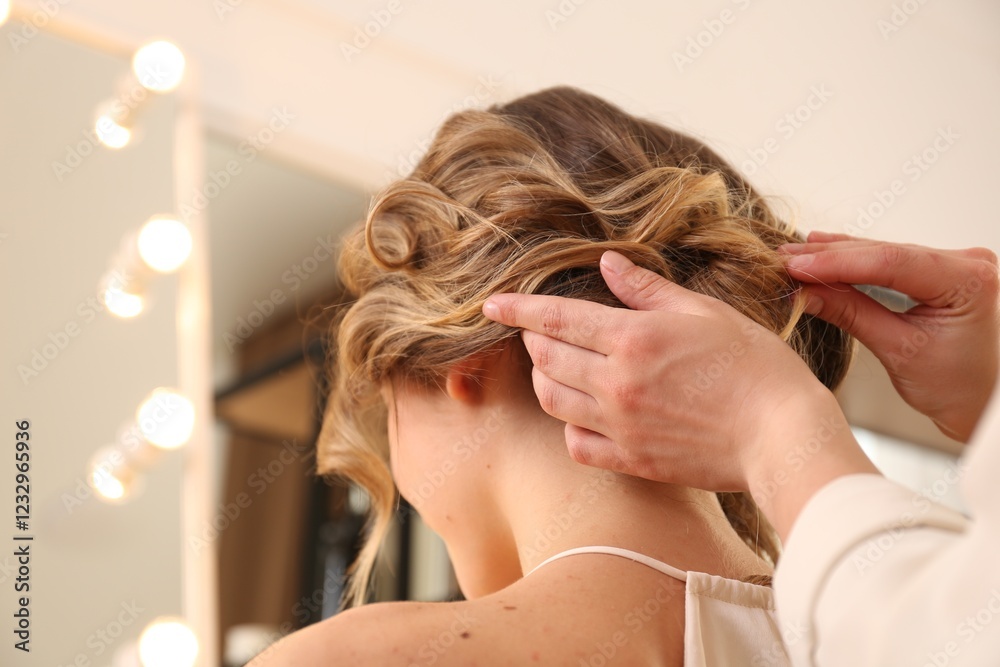 Fototapeta premium Stylist working with client in salon, making hairstyle