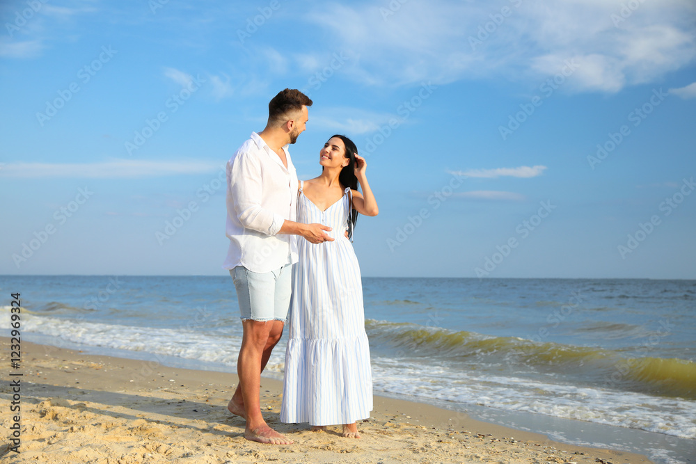 Happy young couple at beach on sunny day Happy young couple at beach on sunny day