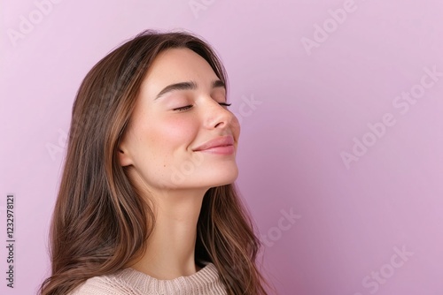 Smiling young woman with long wavy brown hair, glowing skin, eyes closed, minimalist pink background, natural beauty portrait, trendy modern hairstyle, serene and relaxed aesthetic

