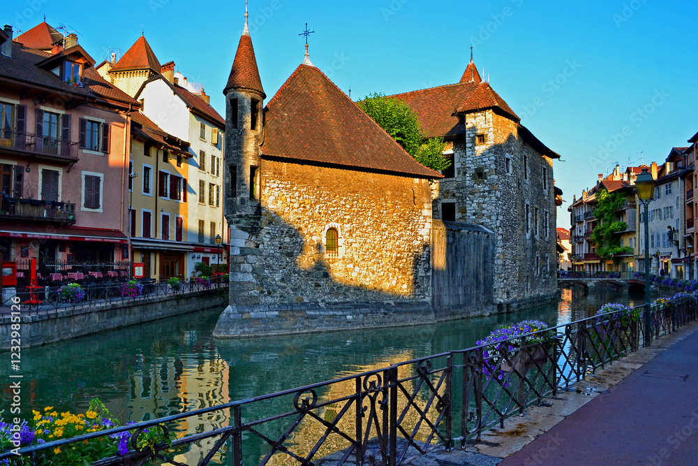 Fototapeta premium Annecy is an old city in eastern France. Reflections of colored houses in the river and flowers along the embankment.