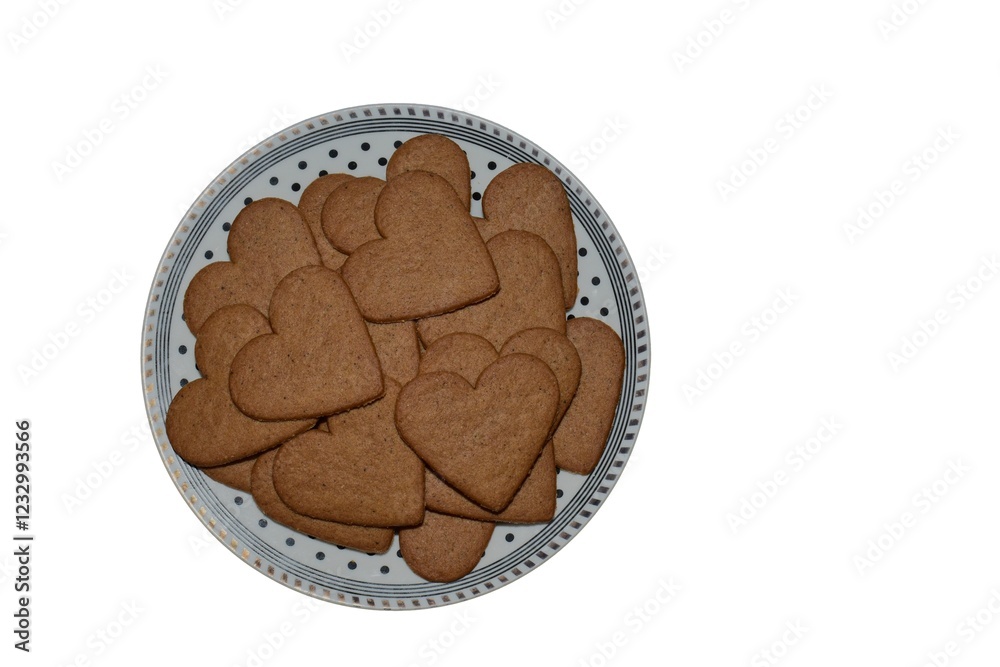 A lot of homemade heart shape cookies in a plate isolated top view. Cooking Valentines biscuits. Baking handmade love day treats. Heart biscuits in a plate. A lot of homemade heart shape cookies in a plate isolated top view. Cooking Valentines biscuits. Baking handmade love day treats. Heart biscuits in a plate.
