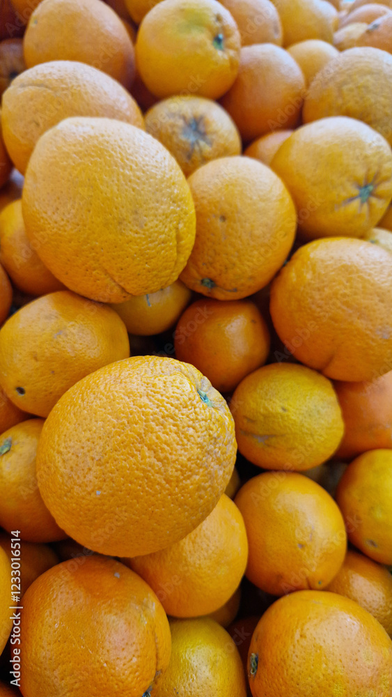 Oranges for sale in a supermarket. Citrus fruits, close-up with selective focus. Oranges in a store. Ripe, juicy, bright orange fruits. Fruits enriched with vitamin C Oranges for sale in a supermarket. Citrus fruits, close-up with selective focus. Oranges in a store. Ripe, juicy, bright orange fruits. Fruits enriched with vitamin C
