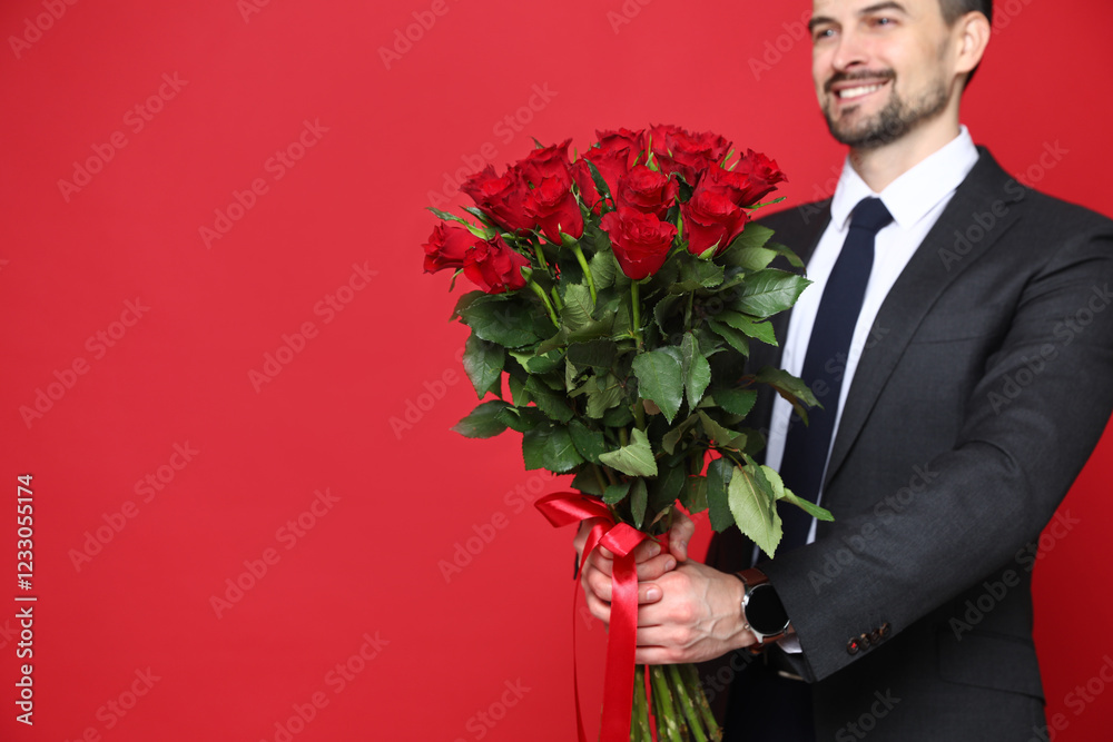 Happy Valentine's Day. Man with bouquet of roses on red background, closeup. Space for text Happy Valentine's Day. Man with bouquet of roses on red background, closeup. Space for text
