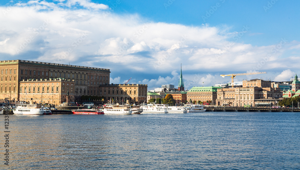 Stockholm, Sweden - 1 October 2022: Gamla Stan, old town in Stockholm at sunset with Riddarholmskyrkan church and boats Stockholm, Sweden - 1 October 2022: Gamla Stan, old town in Stockholm at sunset with Riddarholmskyrkan church and boats