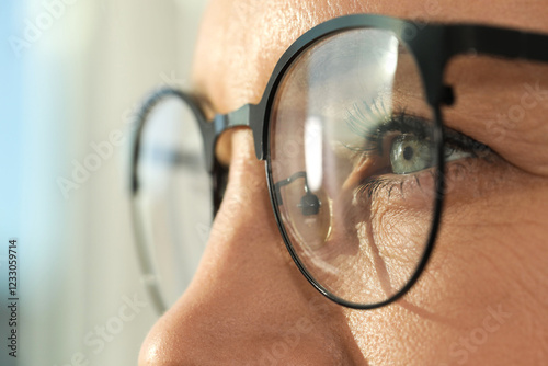 Obraz na plátně Woman wearing stylish glasses on blurred background, closeup