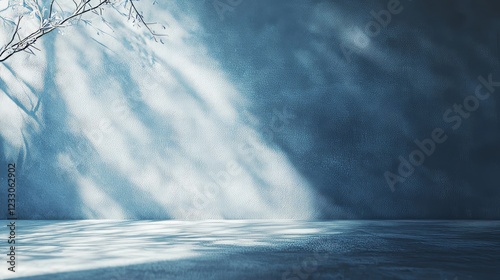 Blue backdrop for displaying products, with sunlight and hazy shadows on the wall. Creates a wintery atmosphere.