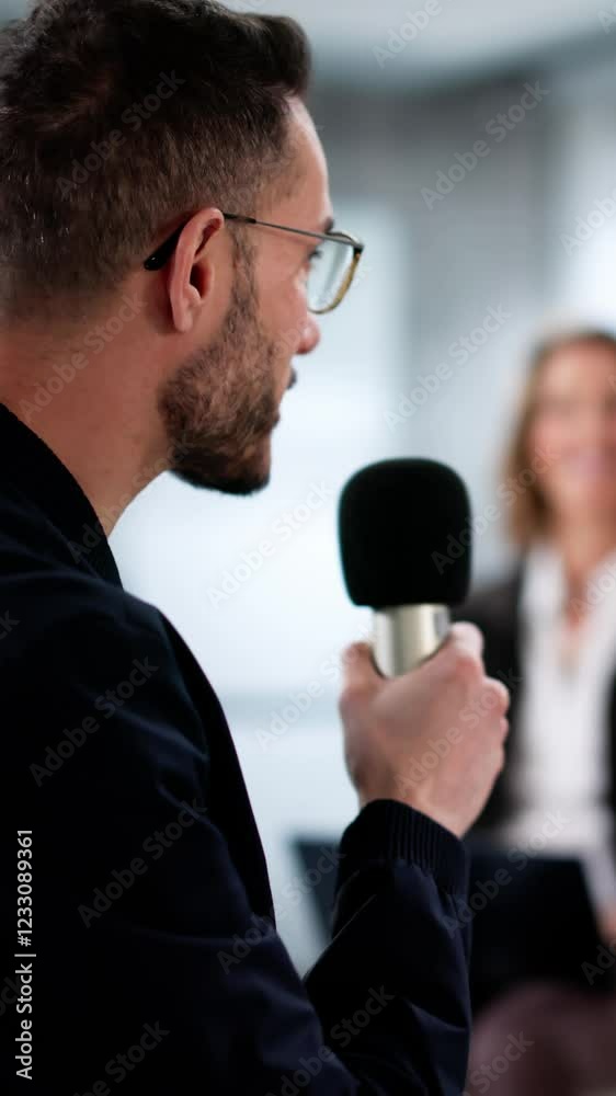 Speaker At Conference Having Speech With Microphone. Debate At Event Speaker At Conference Having Speech With Microphone. Debate At Event