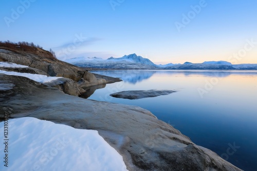 Wallpaper Mural A beautiful view of a lake with mountains in the background. The sky is clear and the sun is setting, creating a serene and peaceful atmosphere Torontodigital.ca