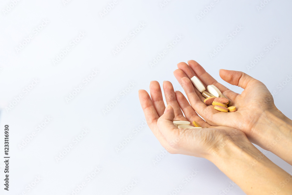 on white background, on the outstretched palms of female hands, there are pills and vitamins of different shapes and colors. suicidal thoughts, depression, health care. on white background, on the outstretched palms of female hands, there are pills and vitamins of different shapes and colors. suicidal thoughts, depression, health care.