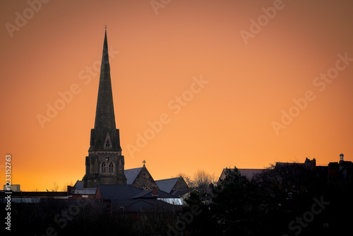 church steeple with sunset behind
