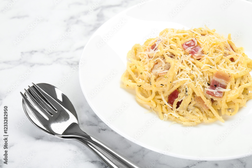 Delicious pasta Carbonara with bacon served on white marble table, closeup Delicious pasta Carbonara with bacon served on white marble table, closeup