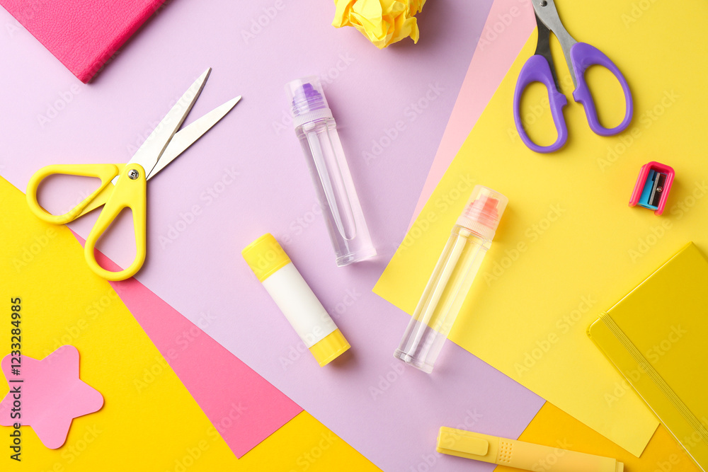 Flat lay composition with glue, scissors and other stationery on color background Flat lay composition with glue, scissors and other stationery on color background