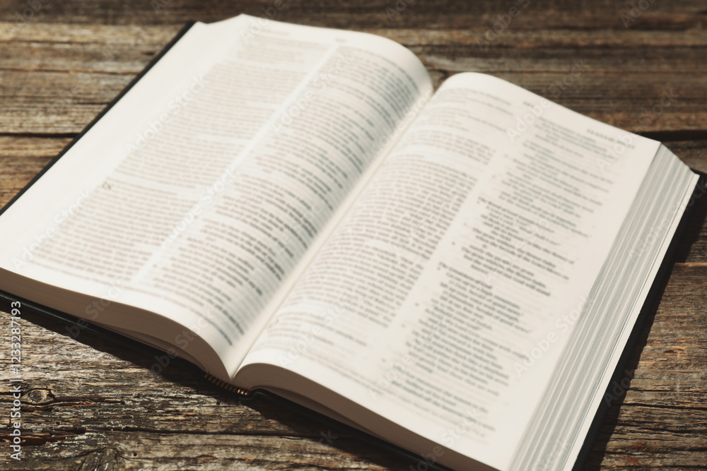 Open Holy Bible in English language on wooden table, closeup Open Holy Bible in English language on wooden table, closeup