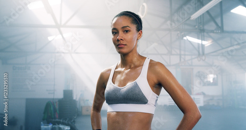 Break, fitness and portrait of woman in gym for rest from exercise, training or workout routine. Health, intense and serious with confident athlete in sports bra for performance challenge or progress