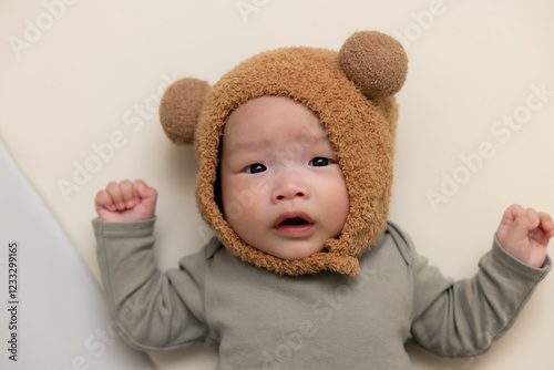 Newborn baby boy wearing fluffy animal hat