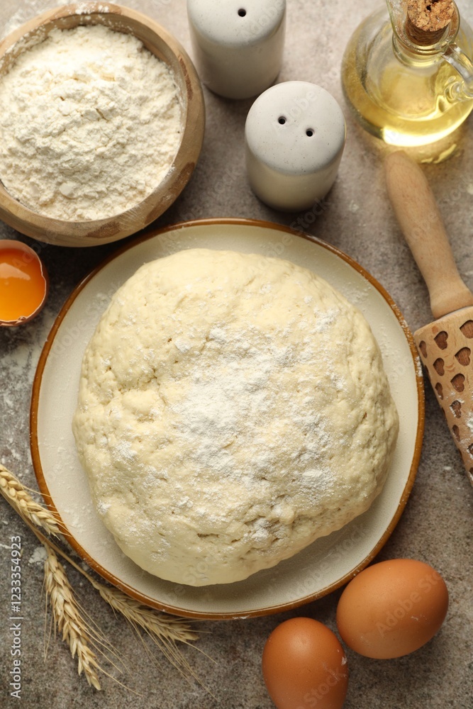 Fresh dough, ingredients and rolling pin on grey table, flat lay Fresh dough, ingredients and rolling pin on grey table, flat lay
