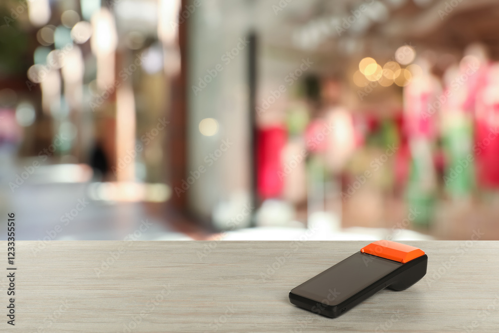 Obraz premium Payment terminal on wooden counter in mall