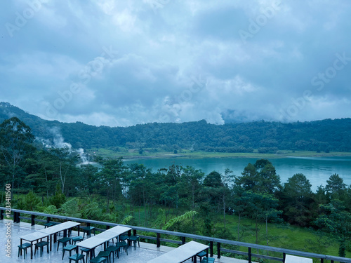 A mesmerizing scene unfolds at a geothermal lake, where nature’s raw power and beauty come together in perfect harmony.The lake, nestled in a remote volcanic landscape and souronded by greeny scenery