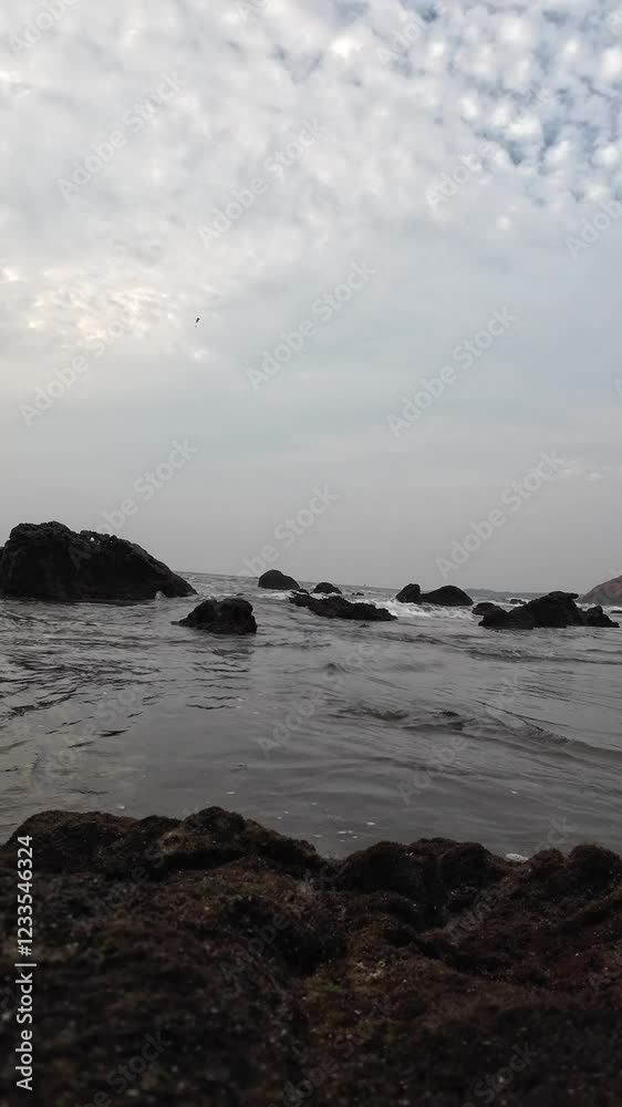 Ocean Waves Crashing On The Small Black Rocks On The Seashore Ocean Waves Crashing On The Small Black Rocks On The Seashore