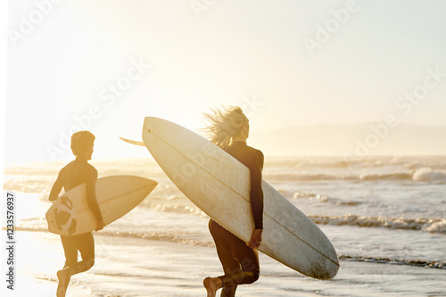 Photography Sunset, enjoying and friends at the beach with surfboards for a hobby, waves and learning an activity