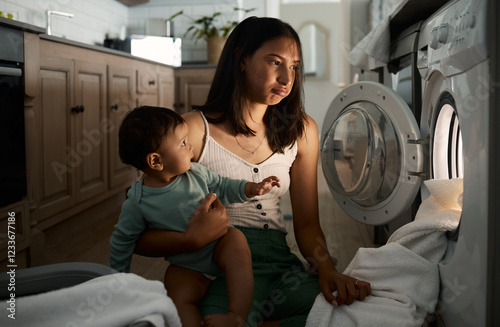 Home, tired and mother with baby for laundry, household chores and parenthood with machine. House, child and mom with burnout expression to wash clothes, responsibility or electric appliance at night