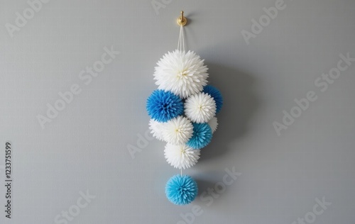 Photo of a handcrafted key chain, in the form of a white and blue circle pattern. photo