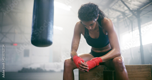 Fototapeta Naklejka Na Ścianę i Meble -  Fitness, boxer and tired woman resting in gym for intense workout, fatigue and exercise recovery. Break, boxing and athlete relax in sports club for wellness, training and breathing for body health