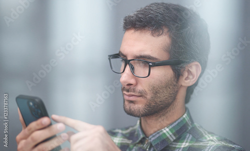 Close-up of a satisfied man holding a phone in his hands