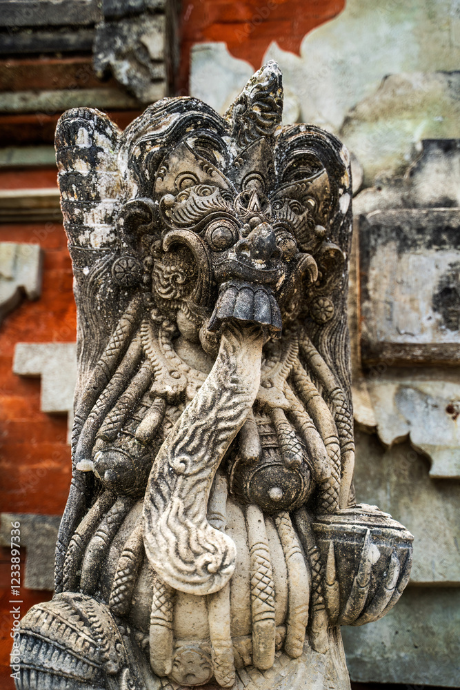 Masterfully carved temple protector statue displays detailed facial features and ornamental designs, weathered by time yet maintaining its fierce presence
