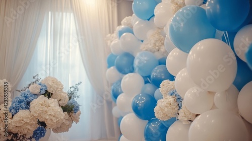 Decorative balloons and floral arrangements create an elegant atmosphere for a celebration in a bright, airy indoor space