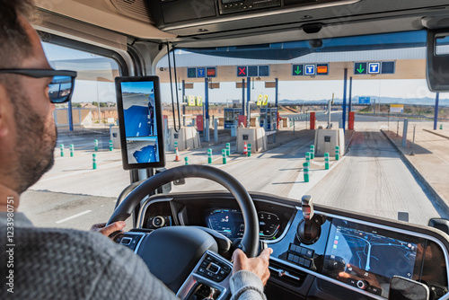 Truck driver operating a heavy vehicle and entering a toll gate marked with 