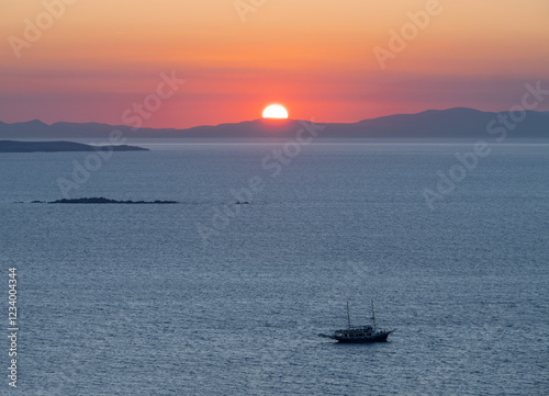 Bild auf Leinwand A sunset cruise ship tour on the island of Mykonos in Greece