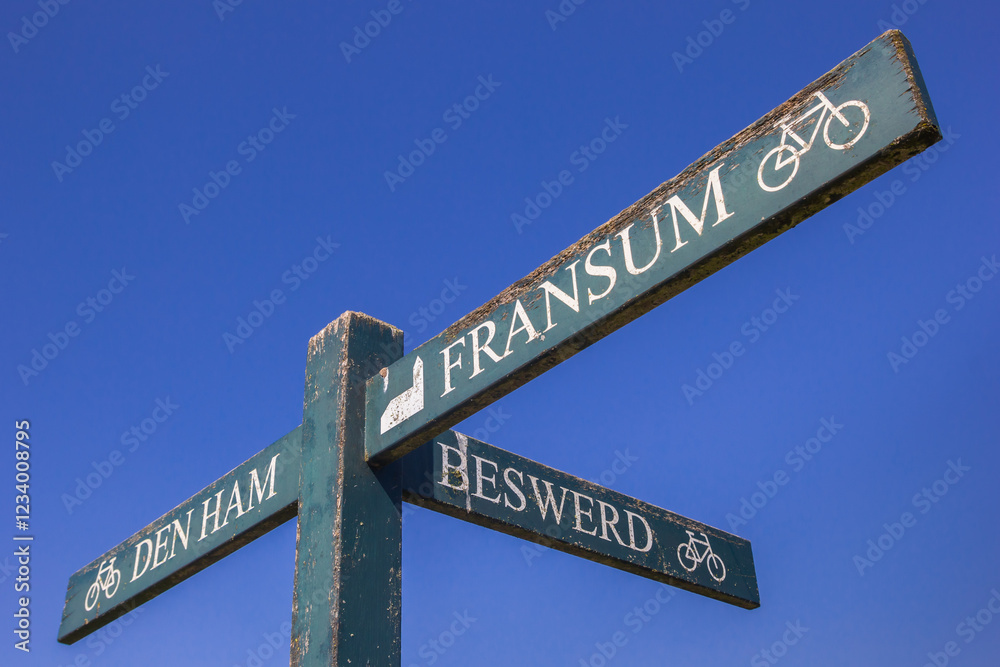 Wooden sign pointing to small villages in Groningen, Netherlands