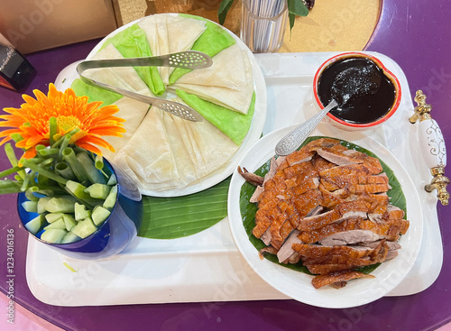 Peking duck set served with pancakes, vegetables, and sweet soy sauce photo